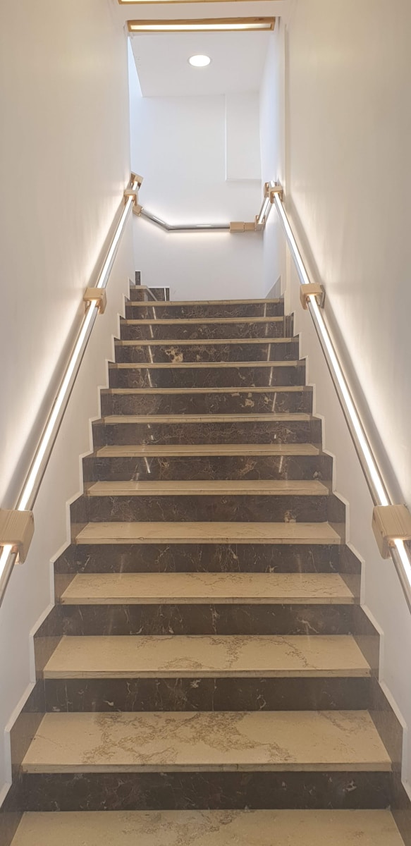 a set of stairs leading up to a skylight