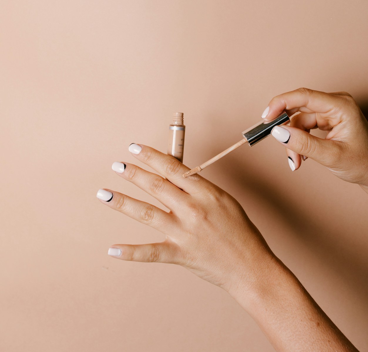 person holding white cigarette stick