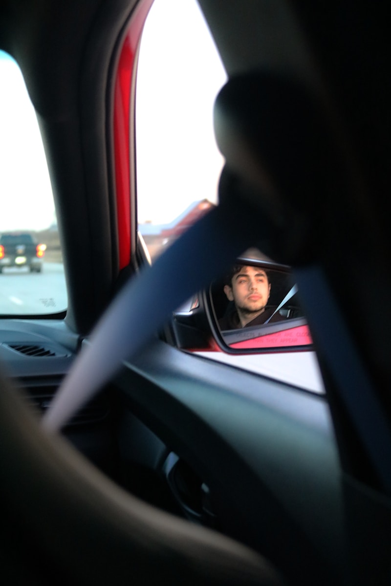 Driver looking in the rearview mirror.